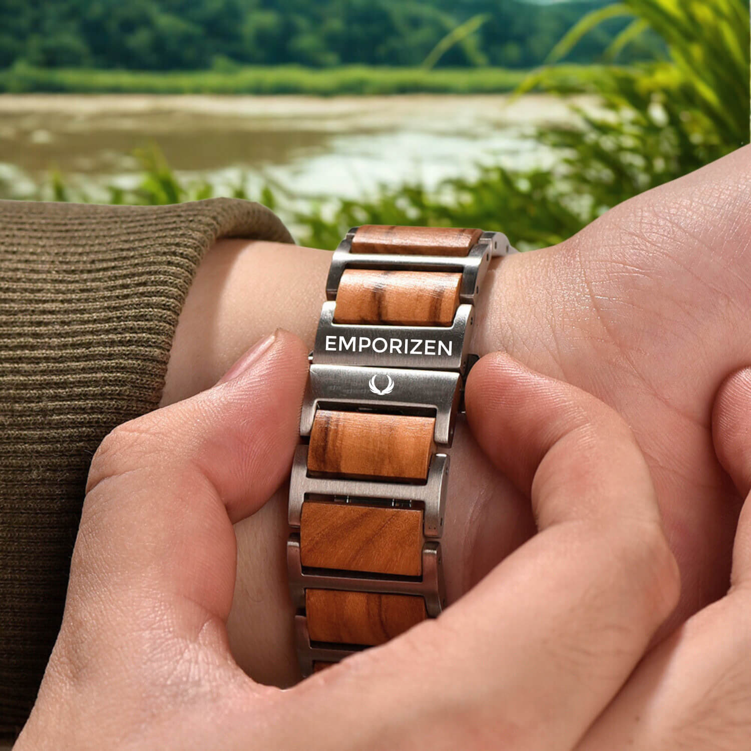 Man wearing a luxury sustainable wooden and metal apple watch with a natural landscape in the background