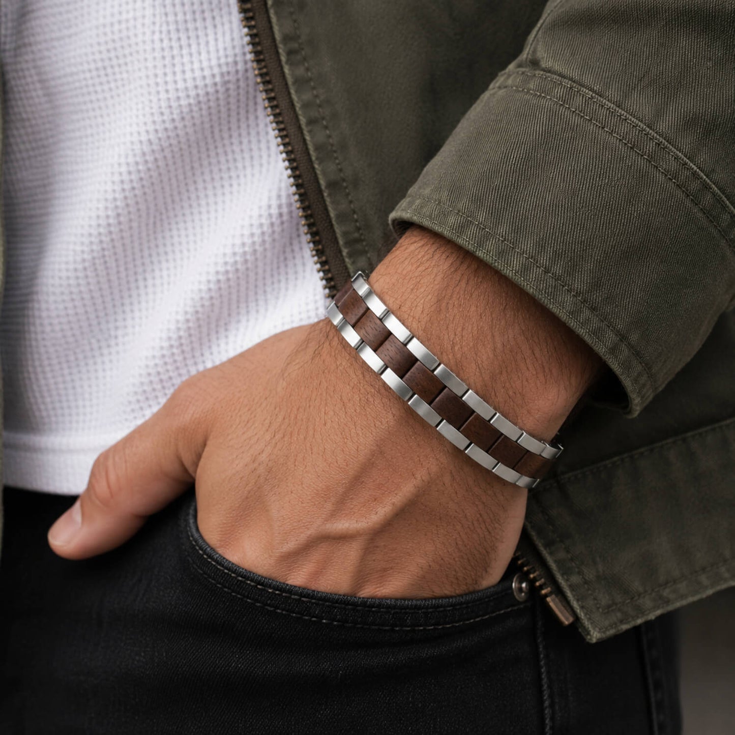 Close-up of a person wearing a silver bracelet on a blurred background