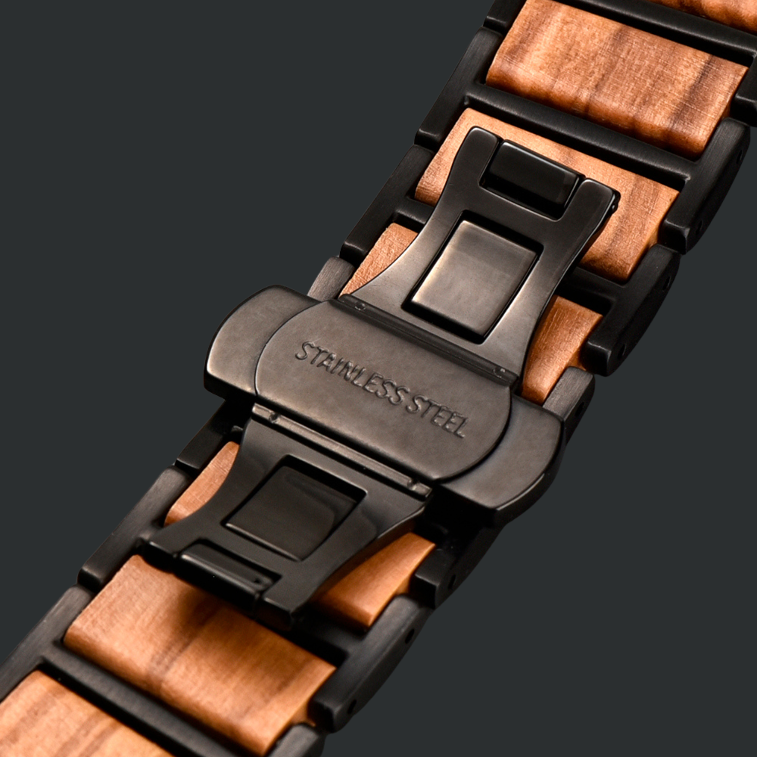 Close-up of a wooden apple watch bracelet with a black butterfly