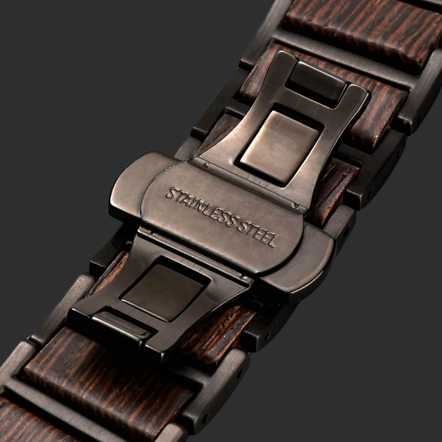 Close-up of a wooden apple watch strap with butterfly clasp