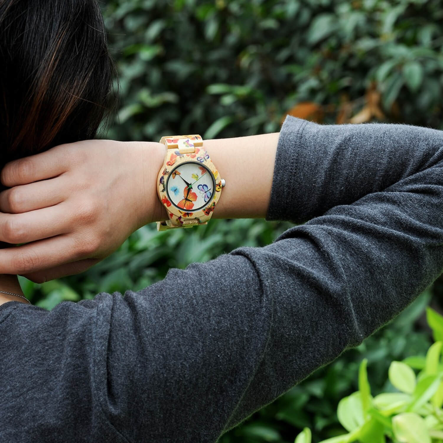 Woman wearing Kyoto Zen 3 Womens Bamboo Wood Watch with Butterfly Design on her wrist