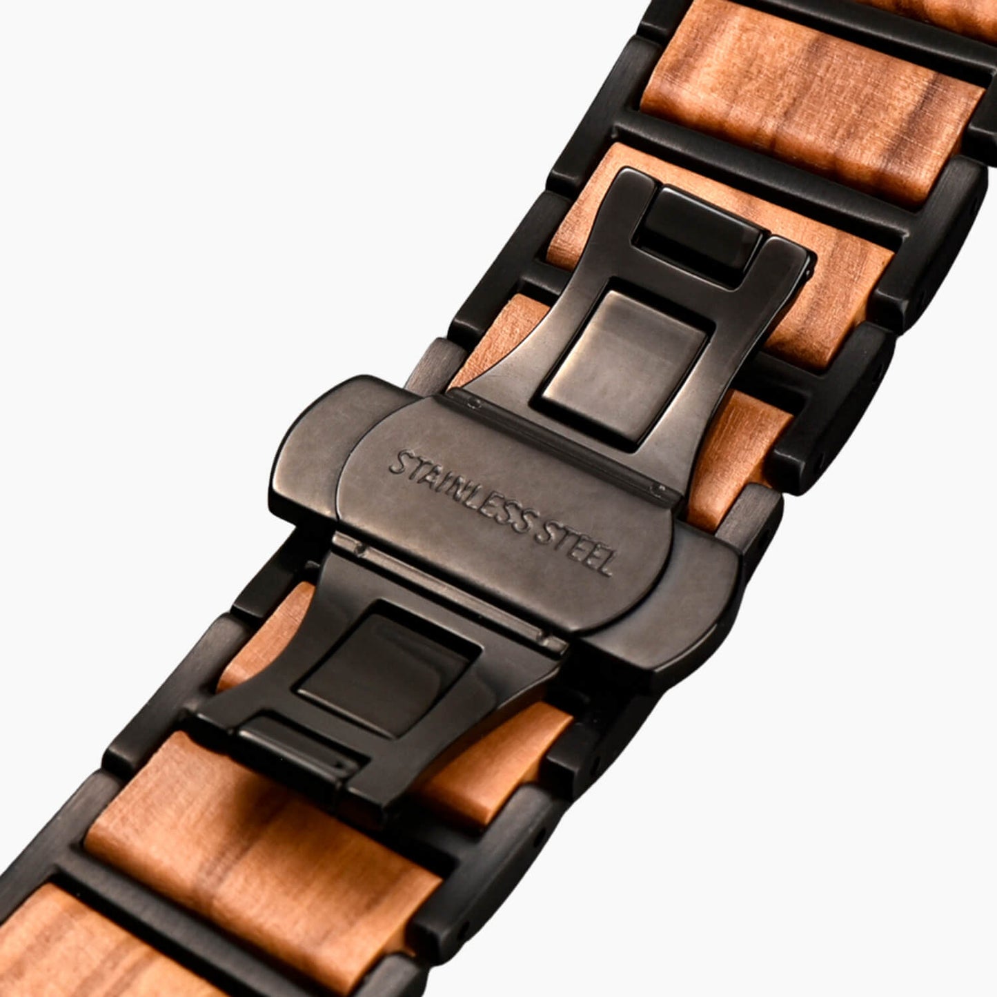 Close-up of a wooden apple watch bracelet with a black butterfly