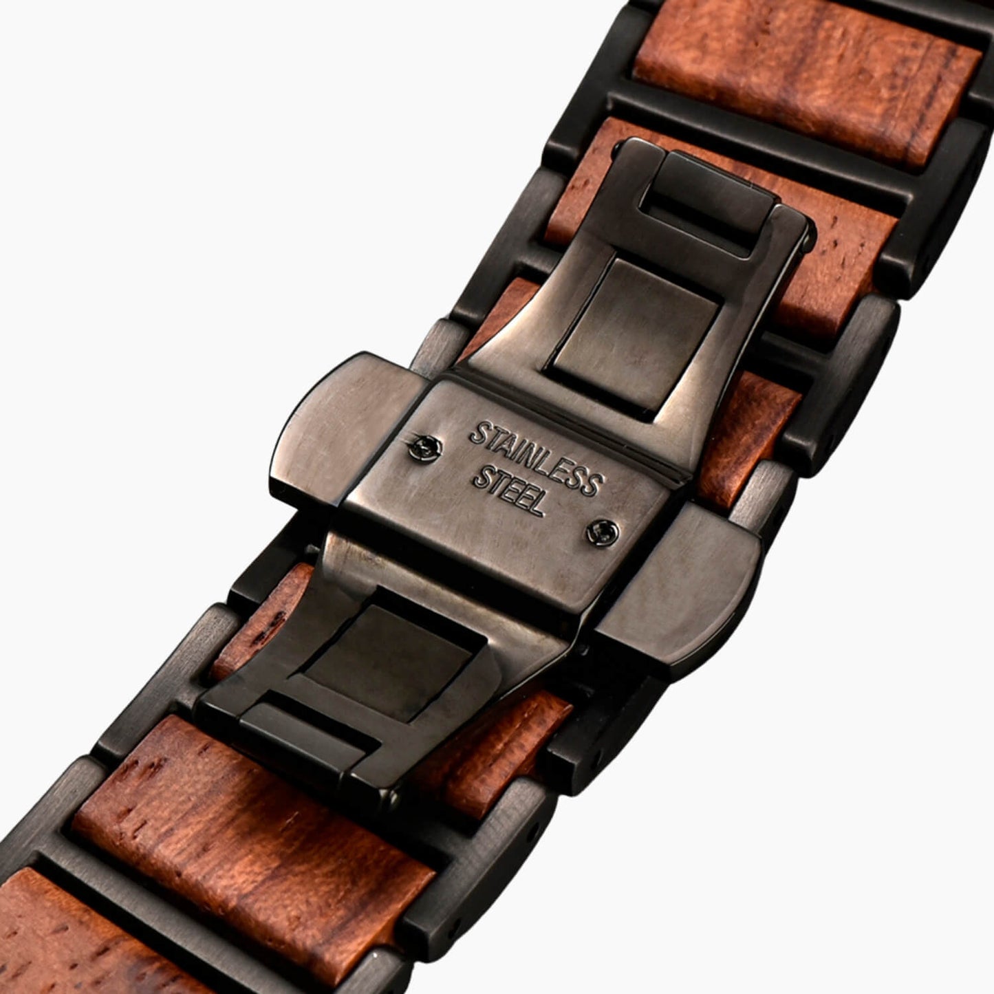 Close-up of a apple watch band with wooden accents and stainless steel butterfly clasp