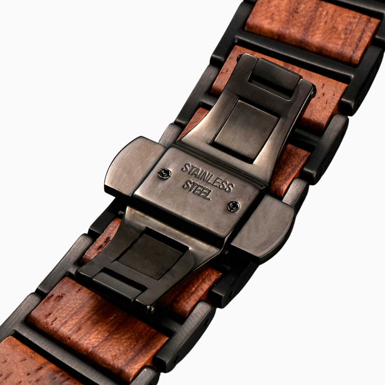 Close-up of a apple watch band with wooden accents and stainless steel butterfly clasp
