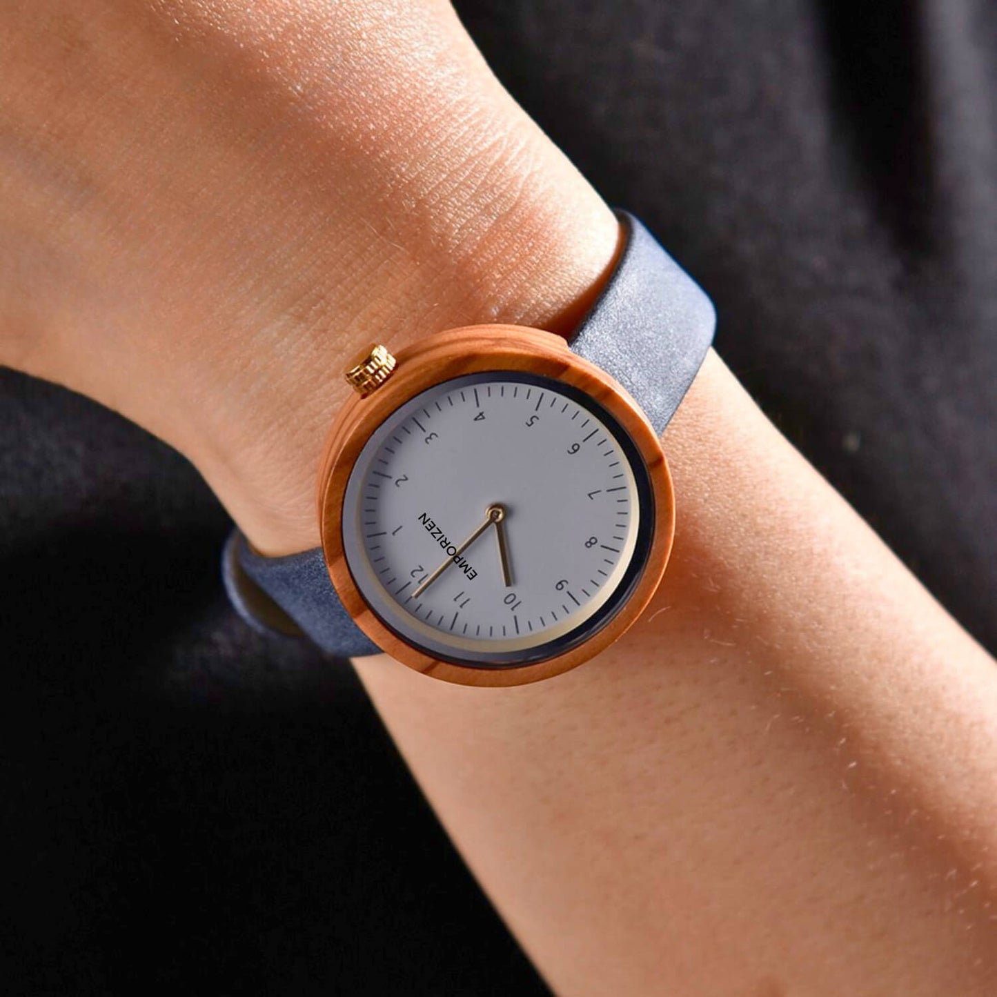 Woman wearing Stockholm Navy wooden and leather watch on her wrist